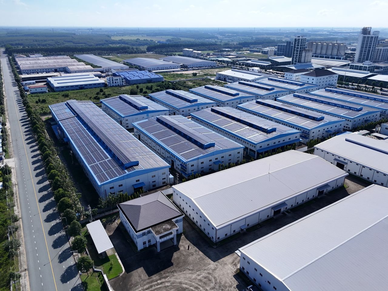 Aerial view of industrial buildings in Thành phố Thủ Dầu Một, Bình Dương, showcasing extensive solar panels.